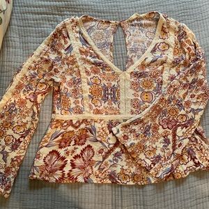 Bell sleeve peplum blouse from Altar’d state